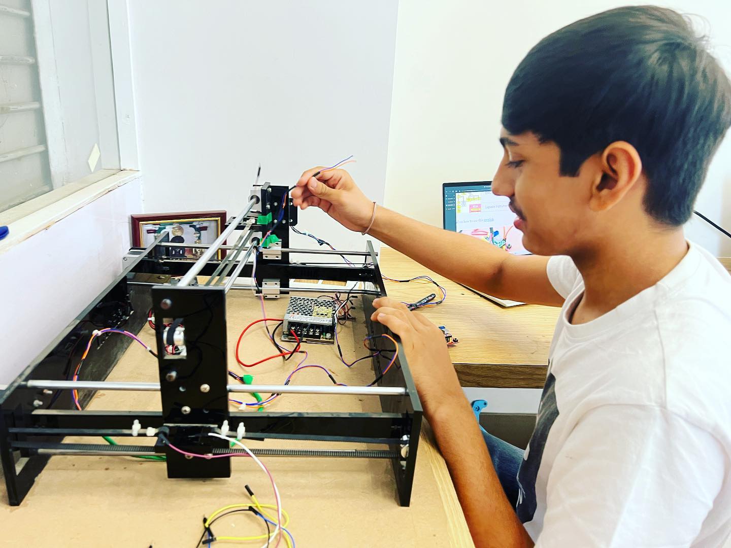 Student Working on Laser Engraving Machine
